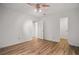 Open bedroom space with wood-look flooring, a ceiling fan, and connecting doors at 5157 Roswell Rd # 1, Atlanta, GA 30342
