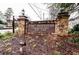 Stone entrance sign for The Summit Condominium Homes featuring landscaped flower beds and available homes signage at 5157 Roswell Rd # 1, Atlanta, GA 30342