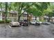A residential apartment complex boasts convenient parking spaces nestled under a canopy of lush trees at 5157 Roswell Rd # 1, Atlanta, GA 30342