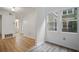Hallway featuring hardwood floors, white walls and a view into the tree-filled landscape at 5157 Roswell Rd # 1, Atlanta, GA 30342