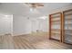 Bright living room featuring hardwood floors, white walls, a ceiling fan, and an open bookshelf at 5157 Roswell Rd # 1, Atlanta, GA 30342