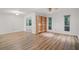 Bright living room with hardwood floors, white walls, a ceiling fan, and an open bookshelf at 5157 Roswell Rd # 1, Atlanta, GA 30342