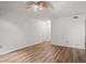 Bright living room featuring hardwood floors, white walls, a ceiling fan and multiple doorways at 5157 Roswell Rd # 1, Atlanta, GA 30342