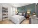 Stylized bedroom featuring bike wall art, geometric bedding, and neutral carpet at 620 Lobelia Way, Locust Grove, GA 30248