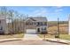 Charming two-story home with brick and gray siding, complemented by a well-manicured lawn at 620 Lobelia Way, Locust Grove, GA 30248