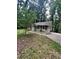 Charming single story home with neutral siding and red shutters surrounded by mature trees and a front yard at 2708 Beacon Dr, Atlanta, GA 30360