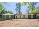 Charming brick home with a modern design, featuring large windows and a welcoming porch at 3350 Pine Meadow Nw Rd, Atlanta, GA 30327