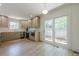 Fully-equipped kitchen with hardwood floors and sliding glass door access to outdoor living spaces at 3350 Pine Meadow Nw Rd, Atlanta, GA 30327