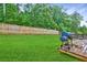 Lush backyard featuring a large deck with a built in grill surrounded by a privacy fence at 336 Freeman Cir, Villa Rica, GA 30180