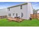 Well-maintained backyard featuring a wooden deck, grill, green grass and privacy fence at 336 Freeman Cir, Villa Rica, GA 30180