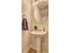 Small powder room featuring pedestal sink, modern fixtures, and a decorative mirror at 336 Freeman Cir, Villa Rica, GA 30180