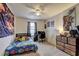 Fun bedroom adorned with a vibrant bedspread, fan, and artwork offering a cheerful and inspiring space for rest and play at 336 Freeman Cir, Villa Rica, GA 30180