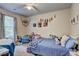 Bright bedroom featuring a ceiling fan, large window and a cozy blue bed with comfortable decorations at 336 Freeman Cir, Villa Rica, GA 30180