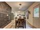 Bright dining room with modern lighting, chalkboard accent wall, and an open view to the kitchen at 336 Freeman Cir, Villa Rica, GA 30180