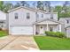 Charming two-story home with a well-maintained lawn, covered porch, and attached two-car garage at 336 Freeman Cir, Villa Rica, GA 30180