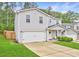Charming two-story home featuring an attached two-car garage, inviting porch and manicured lawn at 336 Freeman Cir, Villa Rica, GA 30180