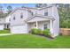 Attractive two-story home boasts a covered porch, green lawn and attached two-car garage at 336 Freeman Cir, Villa Rica, GA 30180