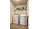 Efficient laundry room with washer, dryer, and ample shelving for storage of supplies at 336 Freeman Cir, Villa Rica, GA 30180