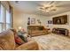 Cozy living room featuring a ceiling fan, large windows, comfy couches, and a large screen television at 336 Freeman Cir, Villa Rica, GA 30180