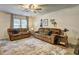 Comfortable living room with neutral walls, ceiling fan, area rug, and lots of comfortable seating at 336 Freeman Cir, Villa Rica, GA 30180
