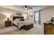 Cozy main bedroom with a comfortable bed, ceiling fan, and warm natural light creating a tranquil and inviting atmosphere at 336 Freeman Cir, Villa Rica, GA 30180