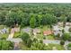 An aerial view showing the neighborhood with tree lined streets, homes, and surrounding greenery at 467 Ravinia Way, Lawrenceville, GA 30044