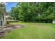 Large backyard with lush green grass, providing a serene outdoor space at 467 Ravinia Way, Lawrenceville, GA 30044