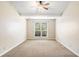 Minimalist bedroom with carpeted floor, large window, and neutral paint tones at 467 Ravinia Way, Lawrenceville, GA 30044