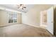 Bright bedroom with carpeted floor, ceiling fan, and large window offering natural light at 467 Ravinia Way, Lawrenceville, GA 30044