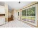 Bright breakfast nook with white tiled floors and large windows overlooking the backyard at 467 Ravinia Way, Lawrenceville, GA 30044
