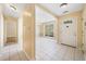 Welcoming entryway with tiled floors, chandelier, and an inviting view to the dining room at 467 Ravinia Way, Lawrenceville, GA 30044