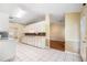 Spacious kitchen with white cabinets, tile floors, breakfast nook and hardwood floor access to living area at 467 Ravinia Way, Lawrenceville, GA 30044