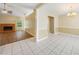 Open-concept living room with hardwood flooring, fireplace, and a view to the dining area at 467 Ravinia Way, Lawrenceville, GA 30044