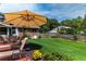 Backyard view with large patio and in-ground pool, plus a manicured lawn, and dining area at 5778 Little Oak Trl, Stone Mountain, GA 30087