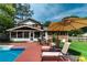 The backyard boasts an in-ground pool, lounge chairs, outdoor seating, and lush green lawn at 5778 Little Oak Trl, Stone Mountain, GA 30087