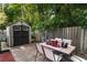 Cozy backyard patio area with a storage shed and an outdoor dining set, perfect for relaxing or entertaining at 5778 Little Oak Trl, Stone Mountain, GA 30087