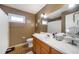 Well-maintained bathroom featuring a tiled floor, single sink vanity, and a shower-tub with curtain at 5778 Little Oak Trl, Stone Mountain, GA 30087
