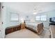 Bright bedroom with a ceiling fan, light blue walls, and light-colored wooden furnishings at 5778 Little Oak Trl, Stone Mountain, GA 30087