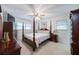 Comfortable bedroom with a four-poster bed, ceiling fan, and traditional-style furniture at 5778 Little Oak Trl, Stone Mountain, GA 30087