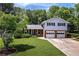 Charming split-level home with a well-manicured lawn and a two-car garage, nestled in a wooded area at 5778 Little Oak Trl, Stone Mountain, GA 30087