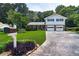 Inviting home exterior with lush lawn, mature landscaping, and a convenient two-car garage at 5778 Little Oak Trl, Stone Mountain, GA 30087