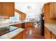 Spacious kitchen boasts wooden cabinets, granite countertops, and modern appliances at 5778 Little Oak Trl, Stone Mountain, GA 30087