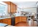 Kitchen with wooden cabinets and granite countertops overlooks the living area at 5778 Little Oak Trl, Stone Mountain, GA 30087