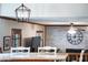 Living area featuring a brick fireplace, ceiling fan, and white chairs at 5778 Little Oak Trl, Stone Mountain, GA 30087