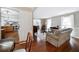 Spacious living room featuring hardwood floors, neutral tones, and open layout to dining area at 5778 Little Oak Trl, Stone Mountain, GA 30087
