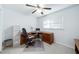 Functional home office with a ceiling fan, computer desk, filing cabinet, and neutral carpet at 5778 Little Oak Trl, Stone Mountain, GA 30087