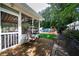 View of the screened-in porch, in-ground pool, and backyard from a brick patio at 5778 Little Oak Trl, Stone Mountain, GA 30087