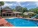 Backyard featuring an in-ground pool with slide, patio seating, and well-maintained lawn at 5778 Little Oak Trl, Stone Mountain, GA 30087