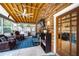 Comfortable screened-in porch with exposed ceiling beams, brick accent wall, and casual seating at 5778 Little Oak Trl, Stone Mountain, GA 30087