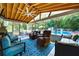 Inviting screened-in porch with a ceiling fan and comfortable furniture that offers a view of the pool at 5778 Little Oak Trl, Stone Mountain, GA 30087